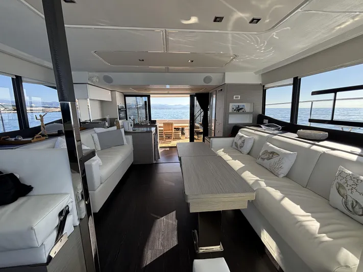 Barcajack Yacht Photos Pics Luxurious interior of 2022 Fountaine Pajot MY6 yacht with elegant seating and ocean view.