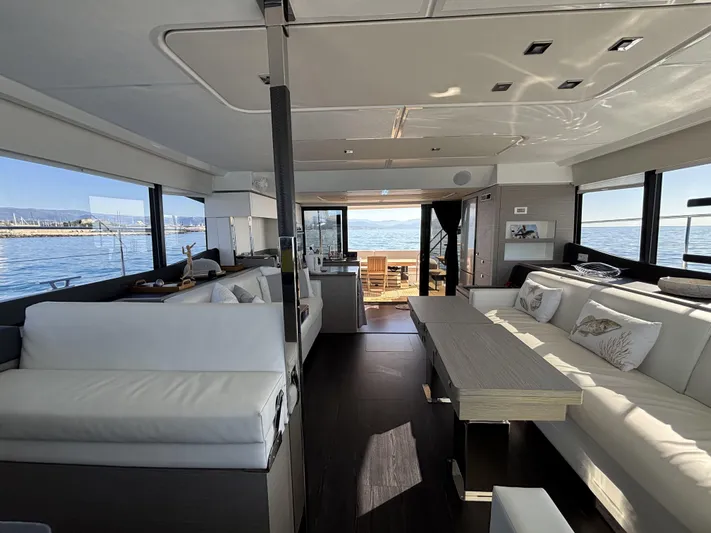 Barcajack Yacht Photos Pics Luxurious interior of 2022 Fountaine Pajot MY6 yacht with elegant seating and ocean view.