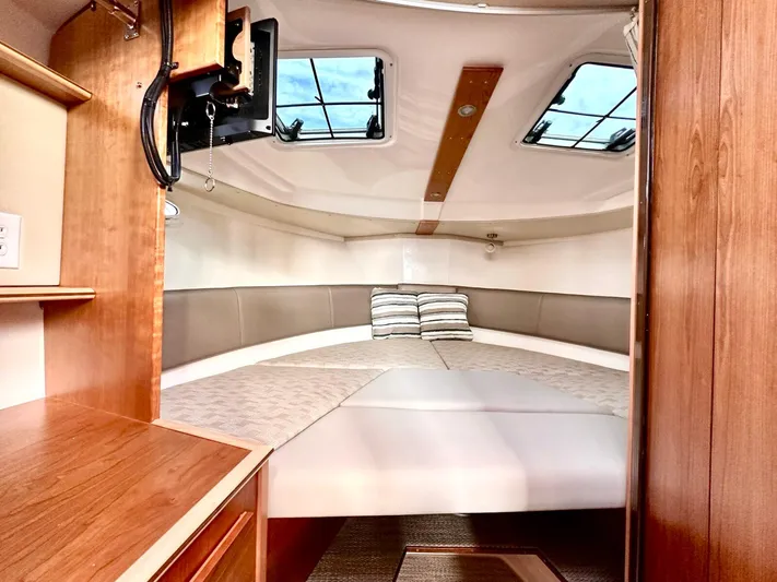  Yacht Photos Pics 2025 Cutwater C-288 Coupe interior cabin with cozy bed and wooden accents.