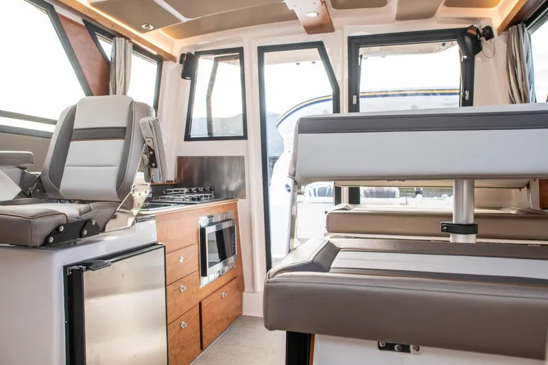  Yacht Photos Pics Interior of 2025 Cutwater C-288 Coupe, featuring modern seating and kitchen amenities.
