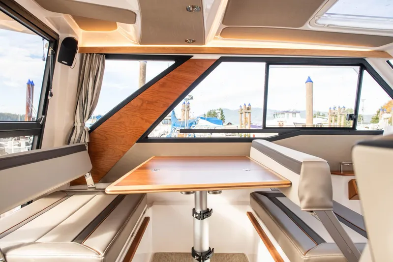  Yacht Photos Pics Interior of 2025 Cutwater C-288 Coupe, featuring a stylish dining area with panoramic windows.