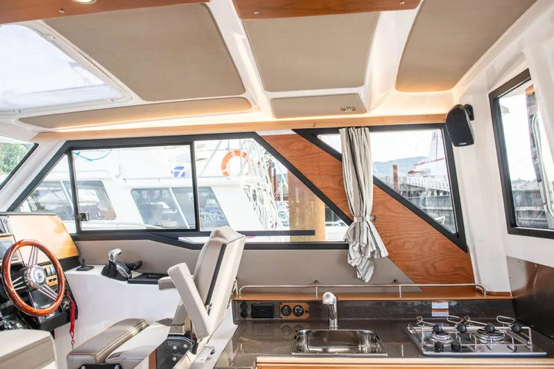  Yacht Photos Pics Interior of 2025 Cutwater C-288 Coupe boat with modern helm and kitchenette.