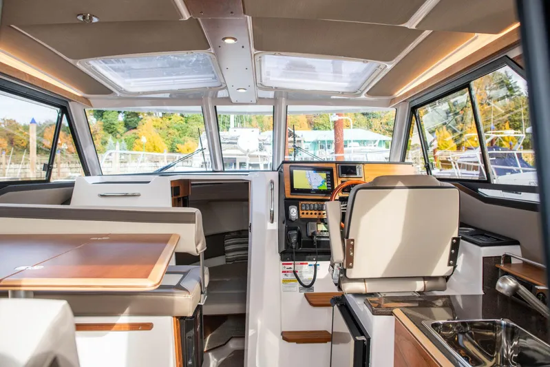  Yacht Photos Pics Interior of 2025 Cutwater C-288 Coupe boat with modern navigation equipment and seating.