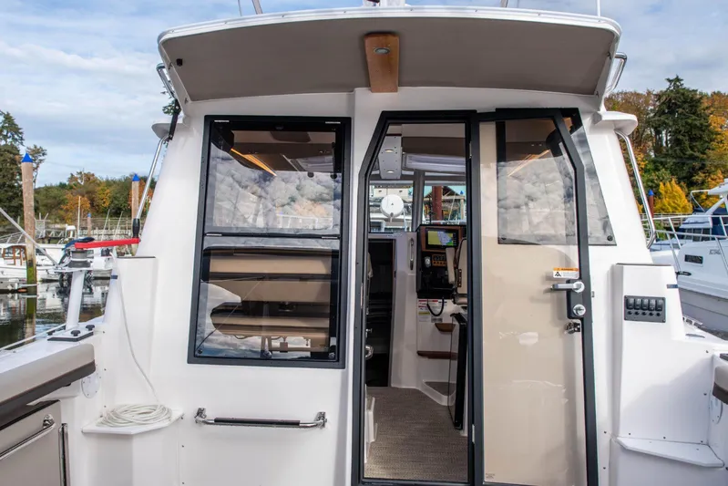  Yacht Photos Pics 2025 Cutwater C-288 Coupe boat exterior with open cabin door at marina.