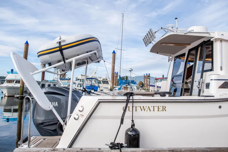  Yacht Photos Pics 2025 Cutwater C-288 Coupe docked, featuring Yamaha engine and mounted dinghy.