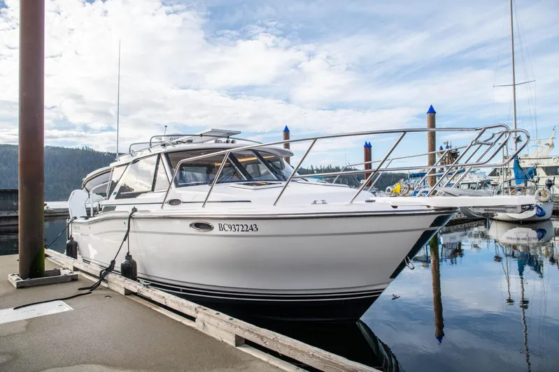  Yacht Photos Pics 2025 Cutwater C-288 Coupe boat docked at marina under cloudy sky.