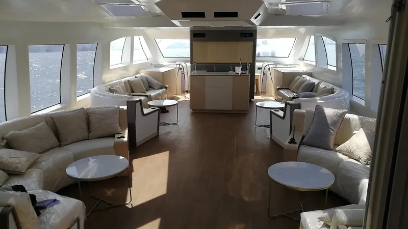  Yacht Photos Pics Luxurious interior of 2025 Mazarin Catamaran HSF-58 with modern seating and panoramic windows.