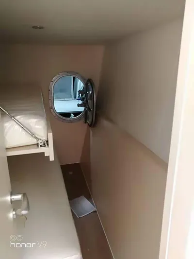  Yacht Photos Pics Interior cabin of 2025 Mazarin Catamaran HSF-58 with porthole and bunk bed.