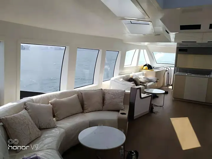  Yacht Photos Pics Luxurious interior of 2025 Mazarin Catamaran HSF-58 with panoramic windows and plush seating.