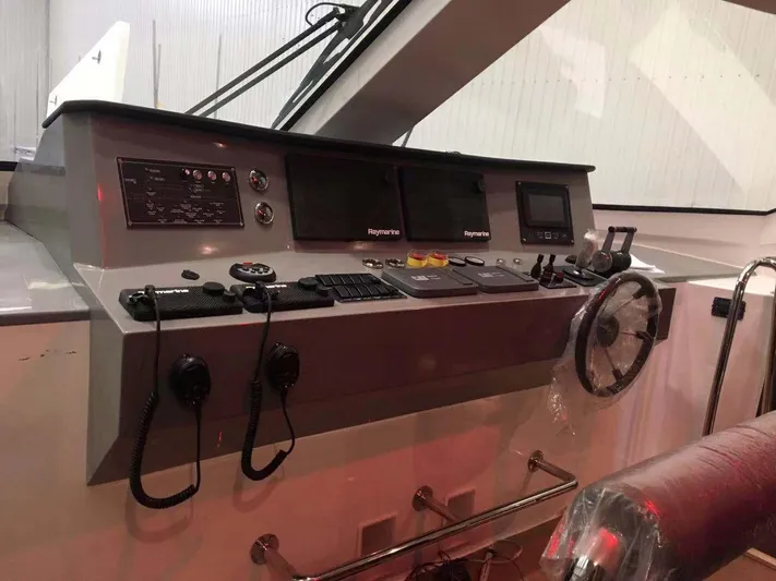  Yacht Photos Pics Control panel of 2025 Mazarin Catamaran HSF-58 with navigation equipment and steering wheel.