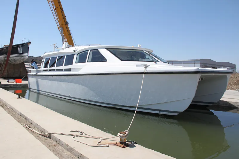  Yacht Photos Pics 2025 Mazarin Catamaran HSF-58 docked, showcasing sleek design and modern features.