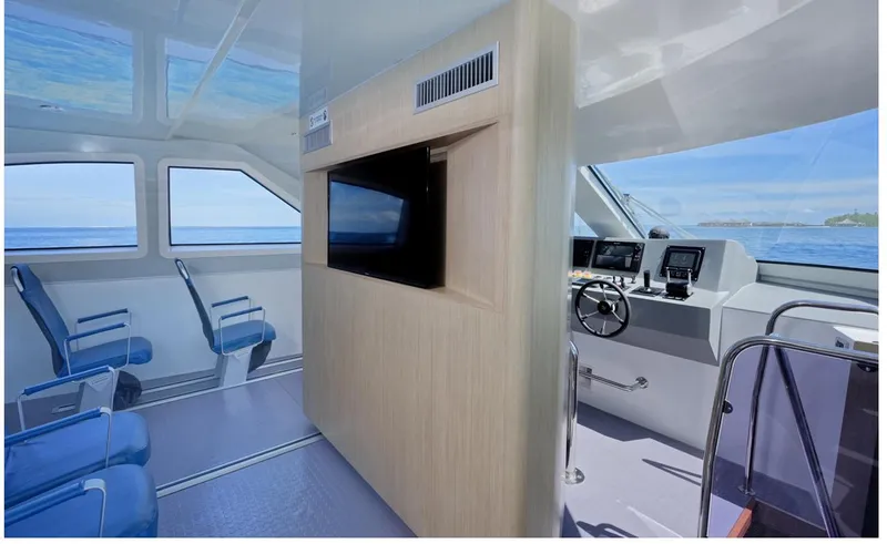  Yacht Photos Pics Interior of 2025 Mazarin Catamaran HSF-58, featuring modern seating and navigation controls.