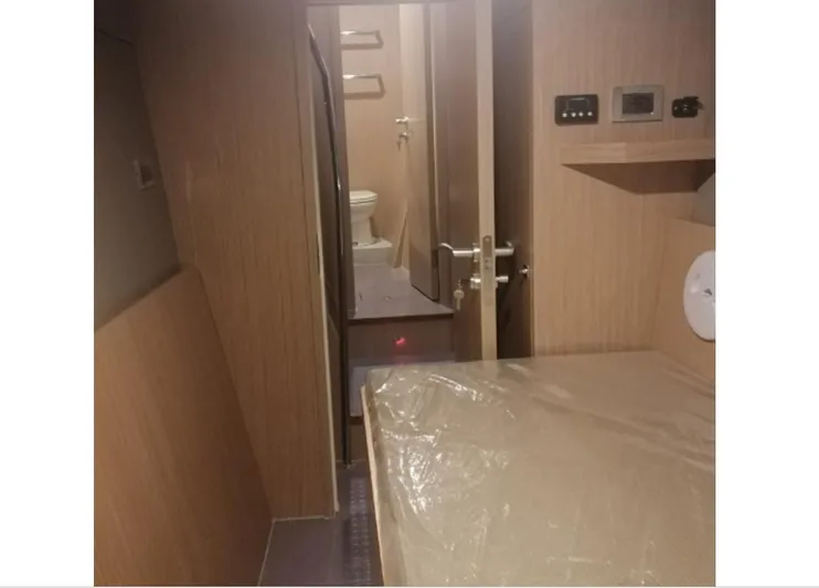 Yacht Photos Pics Interior of 2025 Mazarin Catamaran HSF-58, featuring a compact cabin and bathroom.