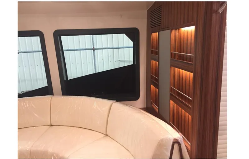  Yacht Photos Pics Luxurious interior of 2025 Mazarin Catamaran HSF-58 with plush seating and elegant wood paneling.