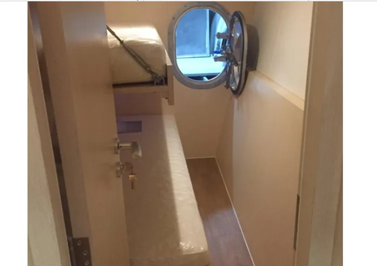  Yacht Photos Pics Compact cabin interior of 2025 Mazarin Catamaran HSF-58 with bunk bed and porthole.