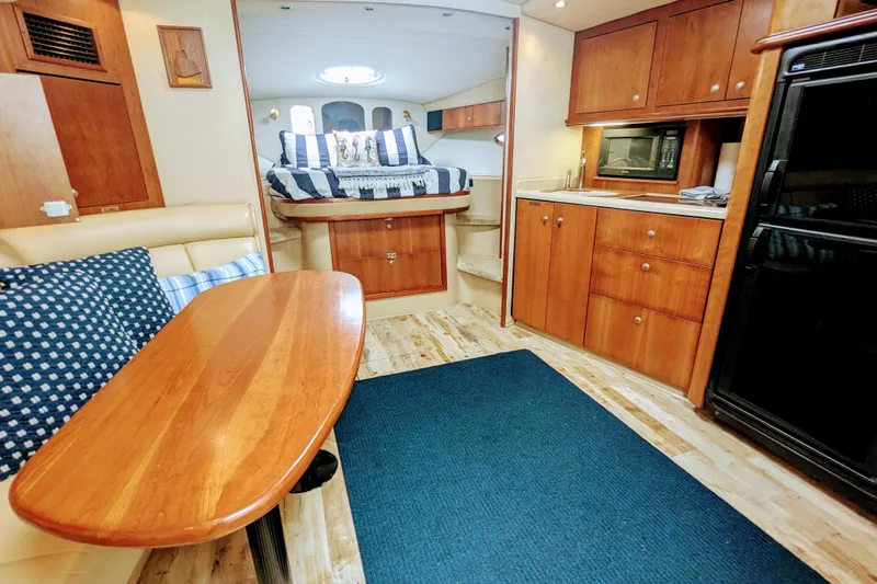  Yacht Photos Pics Interior of 2000 Cruisers Yachts 3870 Express, featuring cozy dining and sleeping areas.