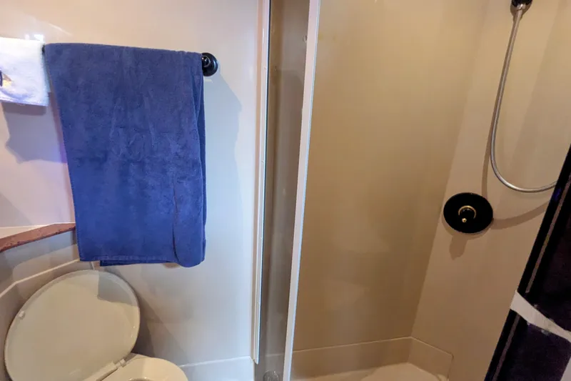  Yacht Photos Pics Bathroom interior of 2000 Cruisers Yachts 3870 Express with shower and towel.