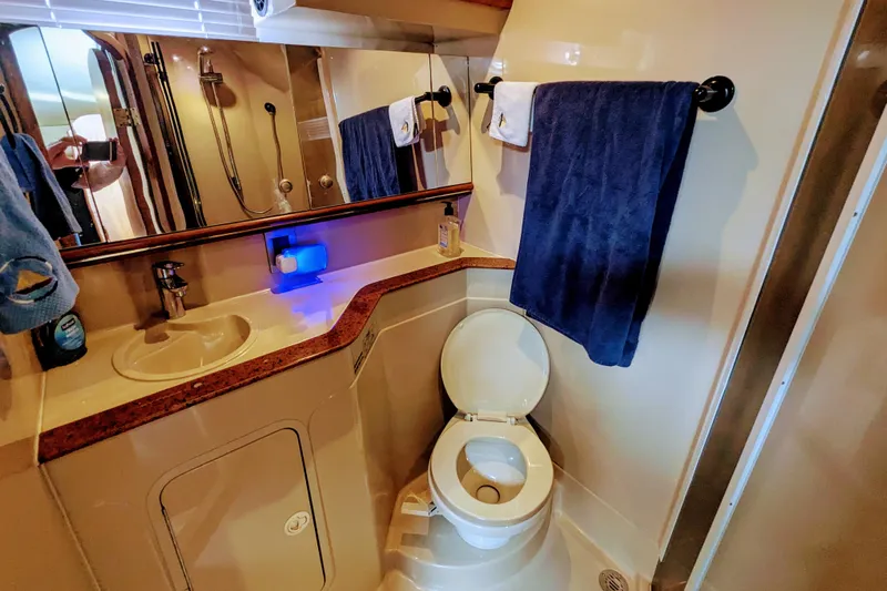  Yacht Photos Pics Bathroom interior of 2000 Cruisers Yachts 3870 Express with sink, toilet, and towels.