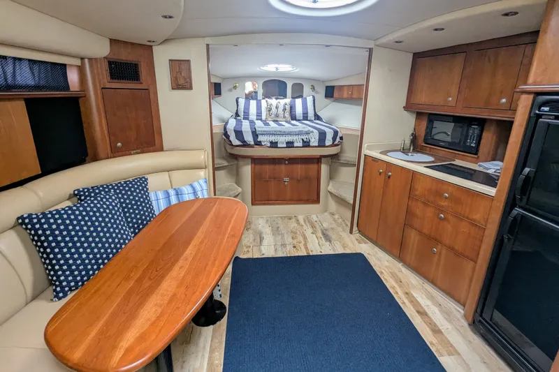  Yacht Photos Pics Luxurious interior of 2000 Cruisers Yachts 3870 Express with cozy seating and kitchenette.