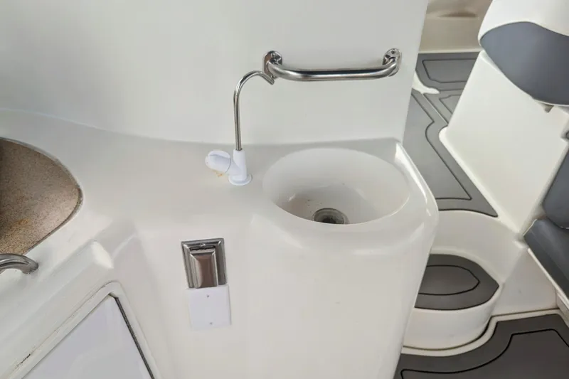  Yacht Photos Pics 2000 Cruisers Yachts 3870 Express interior with sink and seating area.