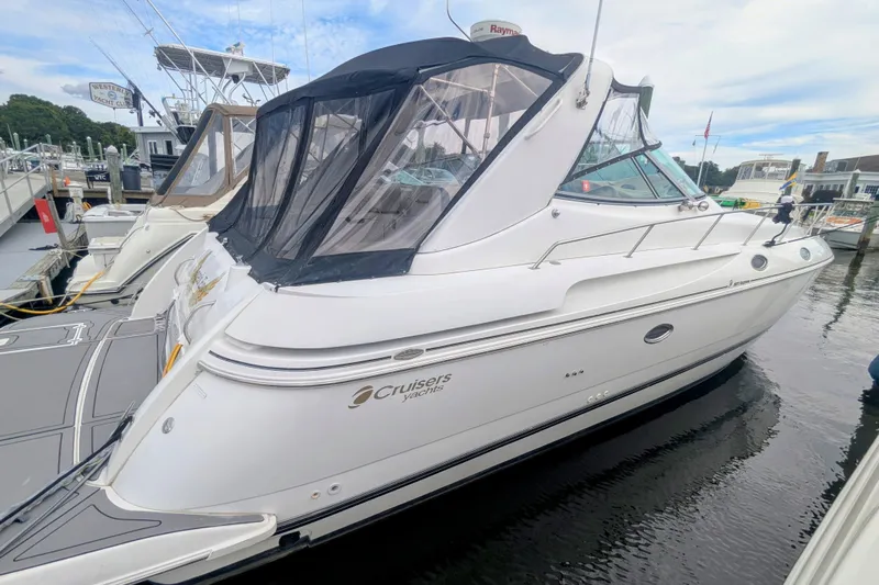  Yacht Photos Pics 2000 Cruisers Yachts 3870 Express docked at marina, featuring sleek design and canopy.