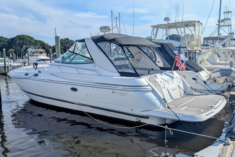  Yacht Photos Pics 2000 Cruisers Yachts 3870 Express docked at marina, featuring sleek design and American flag.