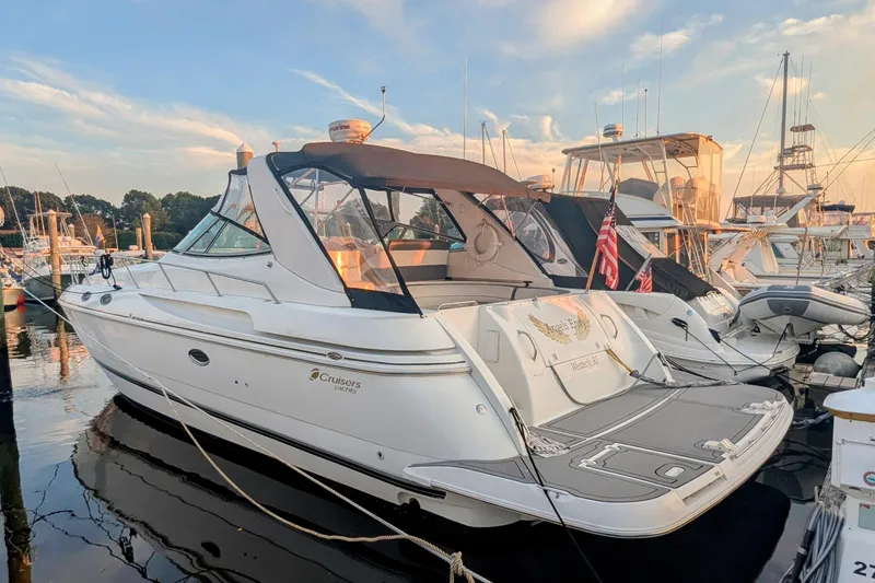  Yacht Photos Pics 2000 Cruisers Yachts 3870 Express docked at marina during sunset.