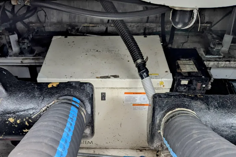  Yacht Photos Pics Engine compartment of 2000 Cruisers Yachts 3870 Express with visible hoses and components.