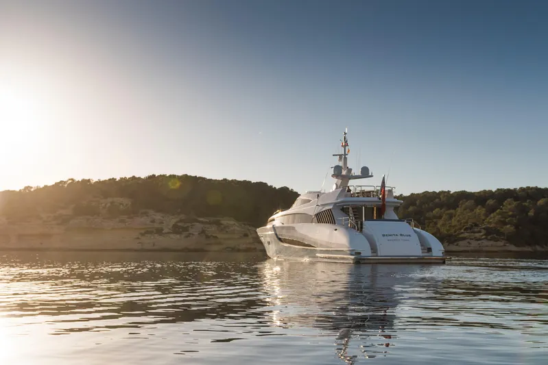Benita Blue Yacht Photos Pics Luxurious 2005 Evolution Yachts Custom yacht cruising at sunset near scenic coastline.
