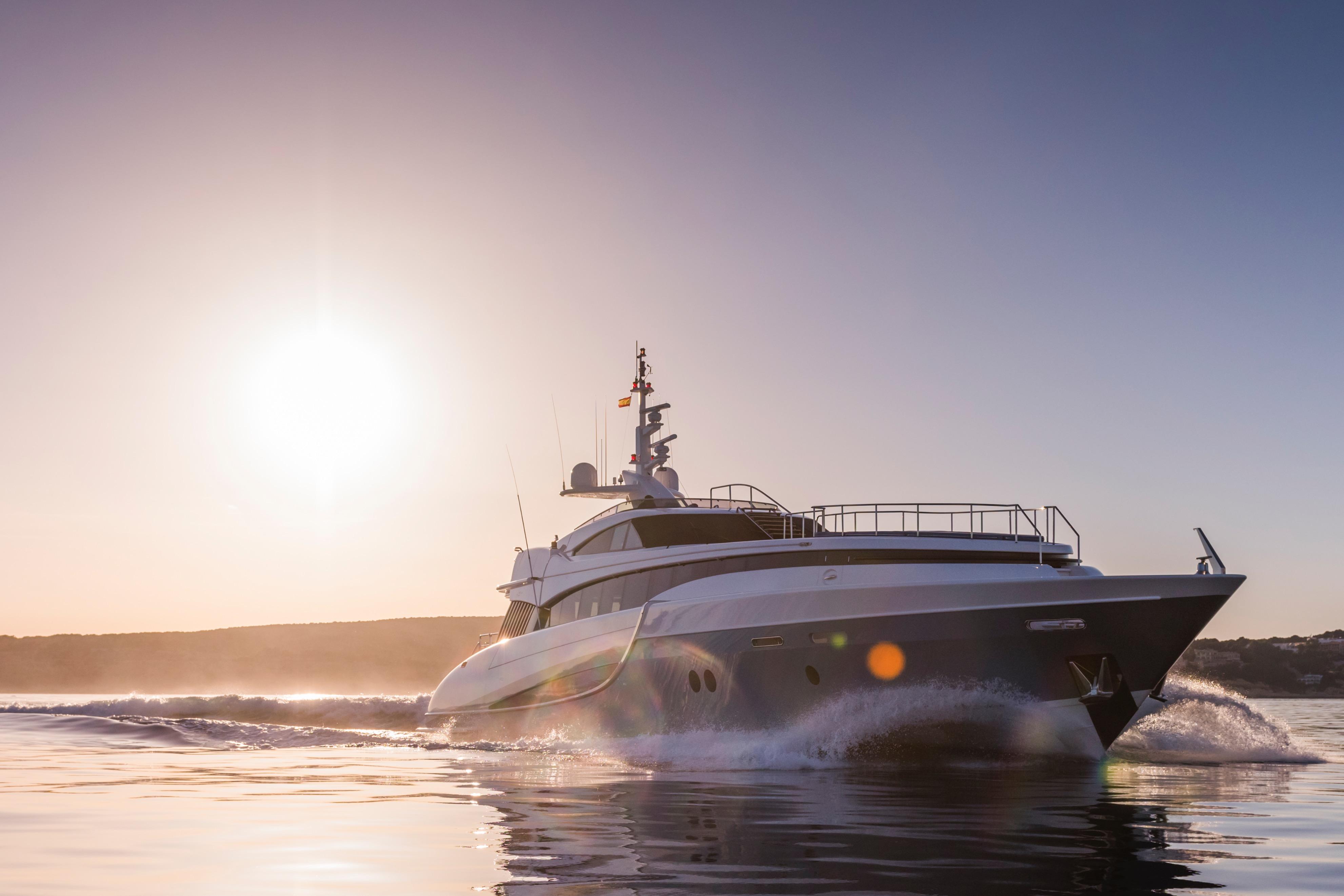 Luxury 2005 Evolution Yachts Custom cruising at sunset on calm waters.