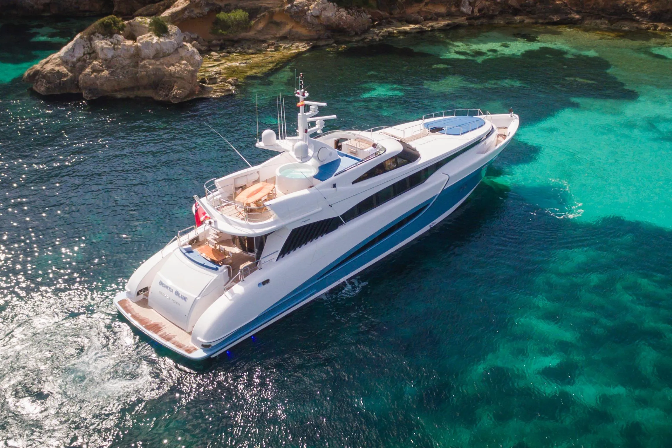 Luxurious 2005 Evolution Yachts Custom cruising in clear turquoise waters.