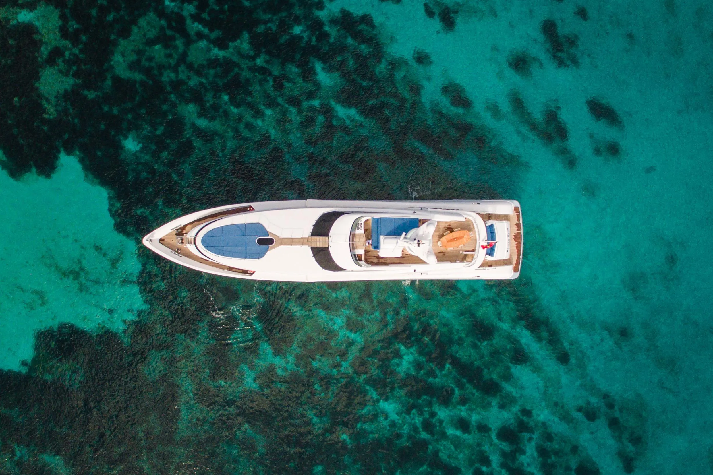 Aerial view of 2005 Evolution Yachts Custom on clear turquoise water.