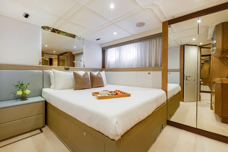 Benita Blue Yacht Photos Pics Luxurious bedroom interior of 2005 Evolution Yachts Custom model with elegant decor and cozy ambiance.