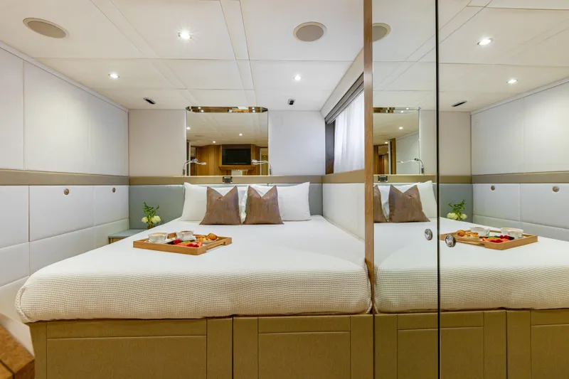 Benita Blue Yacht Photos Pics Luxurious 2005 Evolution Yachts Custom bedroom with elegant decor and breakfast tray.