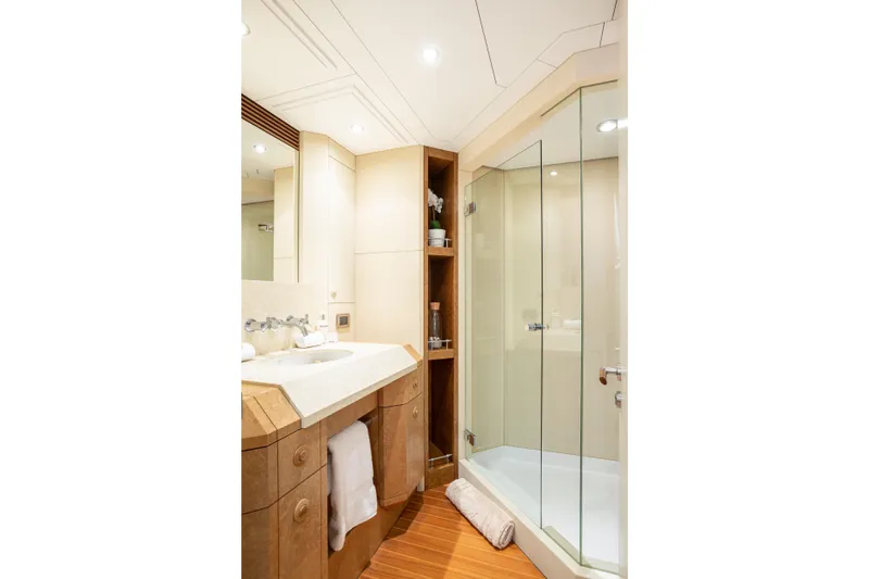Benita Blue Yacht Photos Pics Luxurious yacht bathroom with glass shower, wooden cabinetry, and modern fixtures, Evolution Yachts 2005.