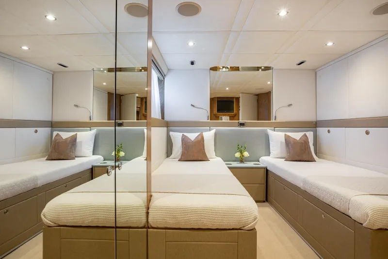 Benita Blue Yacht Photos Pics Luxurious 2005 Evolution Yachts Custom cabin with twin beds and elegant decor.