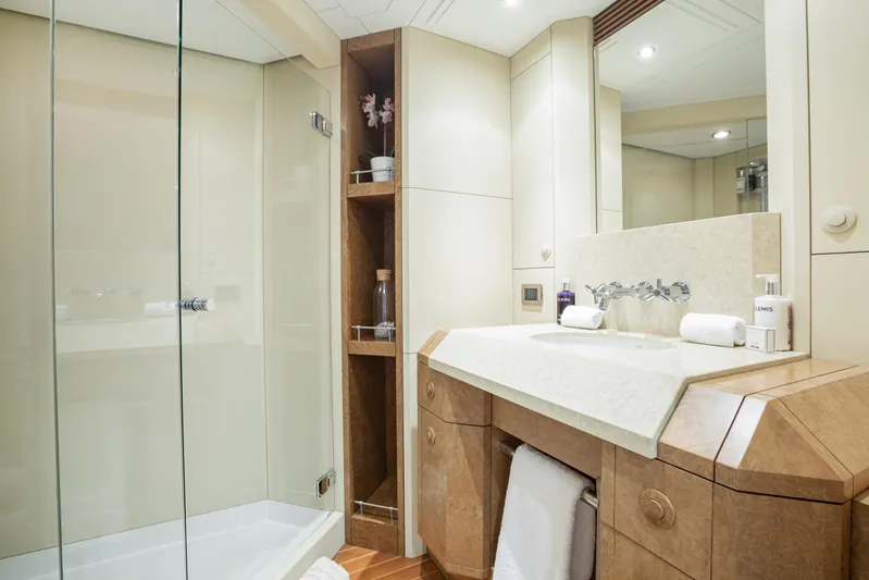 Benita Blue Yacht Photos Pics Luxurious bathroom in 2005 Evolution Yachts Custom, featuring elegant wood and marble finishes.