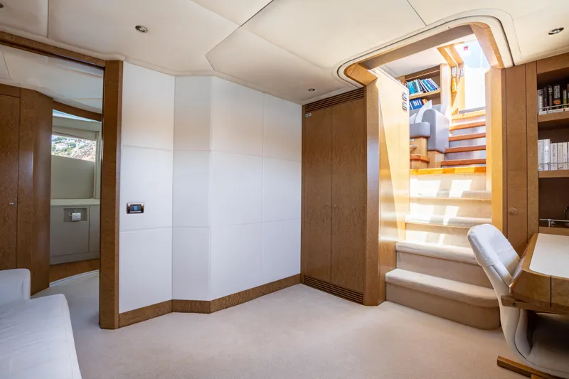 Benita Blue Yacht Photos Pics Luxurious interior of 2005 Evolution Yachts Custom model with elegant wood finishes and staircase.