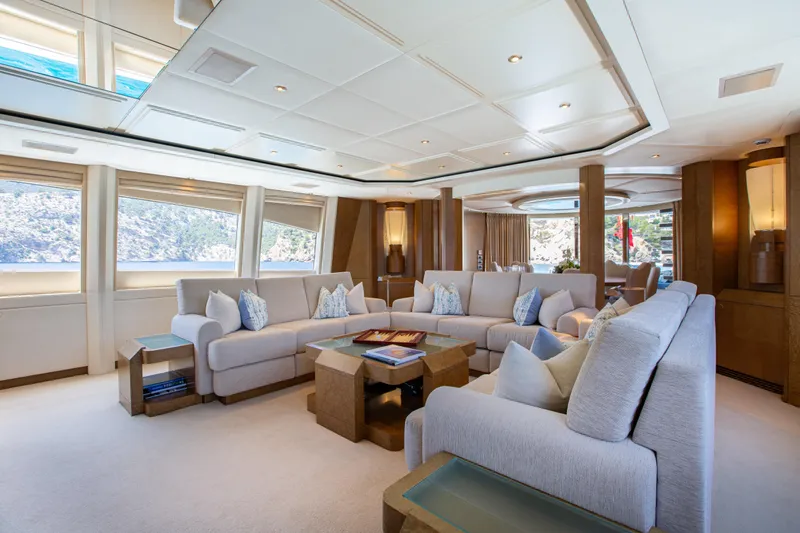 Benita Blue Yacht Photos Pics Luxurious interior of 2005 Evolution Yachts Custom model, featuring elegant seating and panoramic windows.