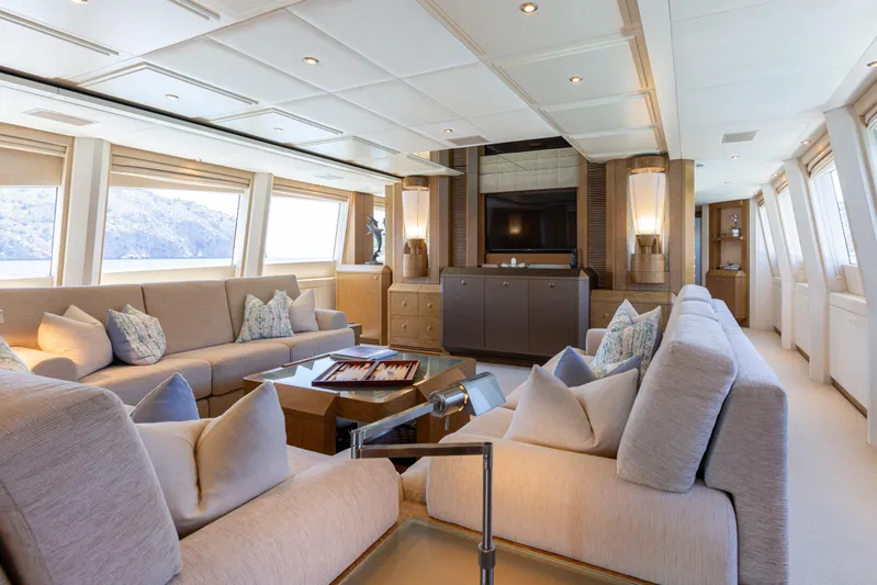 Benita Blue Yacht Photos Pics Luxurious interior of 2005 Evolution Yachts Custom model, featuring elegant seating and large windows.