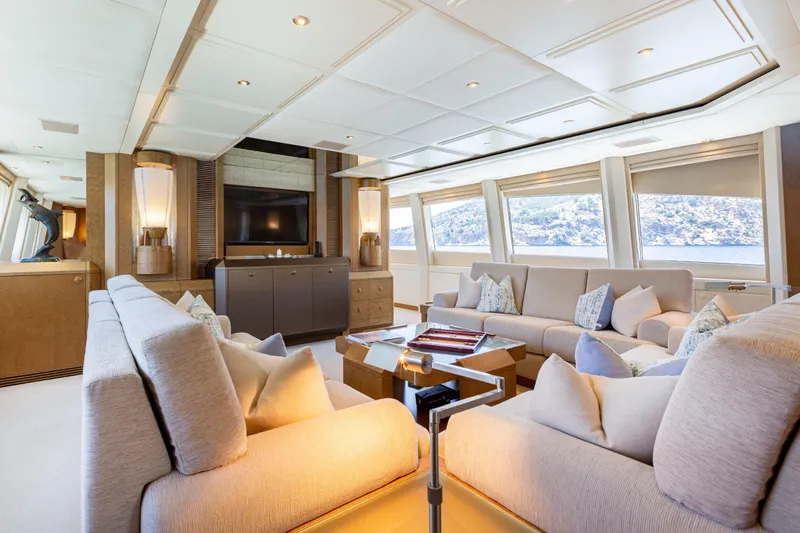 Benita Blue Yacht Photos Pics Luxurious interior of 2005 Evolution Yachts Custom model, featuring elegant seating and large windows.