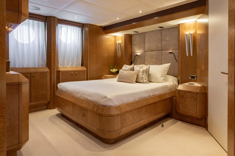 Benita Blue Yacht Photos Pics Luxurious 2005 Evolution Yachts Custom bedroom with elegant wood paneling and plush bedding.