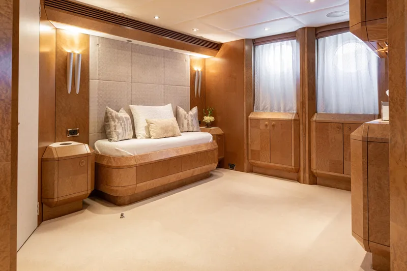 Benita Blue Yacht Photos Pics Luxurious 2005 Evolution Yachts Custom interior with elegant wood paneling and plush bedding.