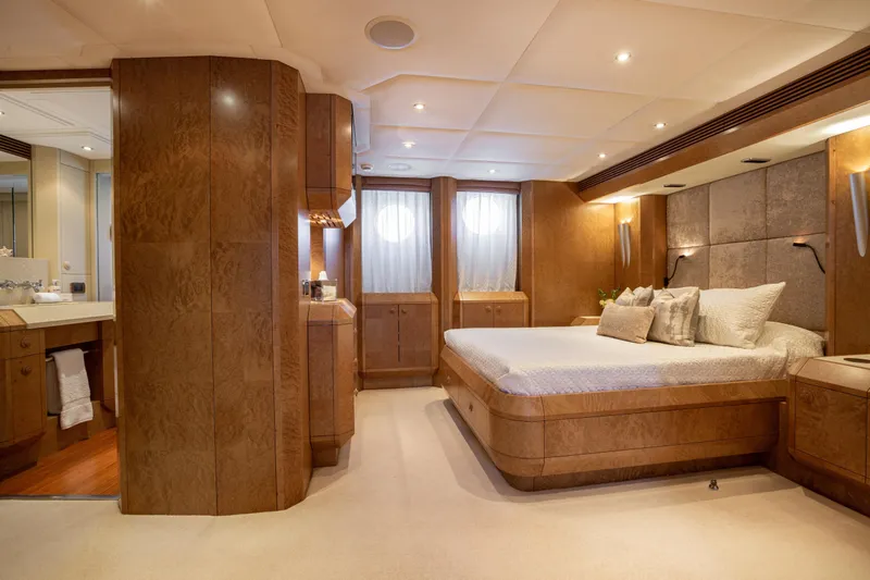 Benita Blue Yacht Photos Pics Luxurious 2005 Evolution Yachts Custom bedroom with elegant wood paneling and modern lighting.