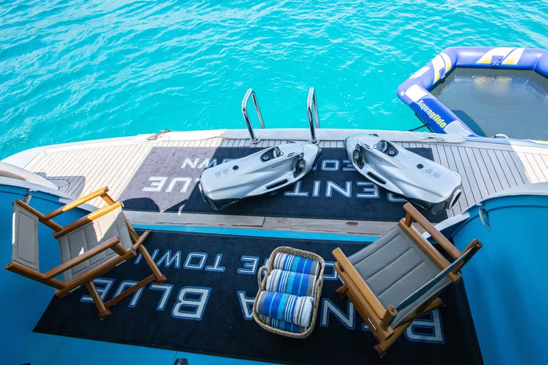 Benita Blue Yacht Photos Pics Luxury yacht deck with chairs, sea scooters, and inflatable water platform, Evolution Yachts Custom 2005.