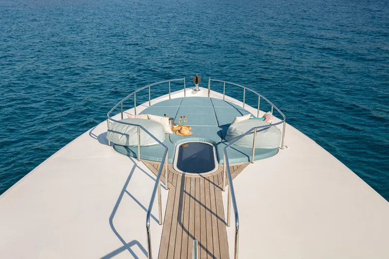 Benita Blue Yacht Photos Pics Luxurious 2005 Evolution Yachts Custom deck with seating, overlooking serene ocean waters.