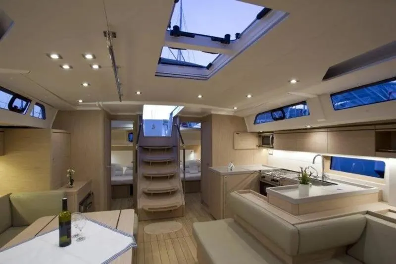 Miss Alice Yacht Photos Pics Luxurious interior of 2018 Beneteau 51.1 yacht with modern kitchen and seating area.