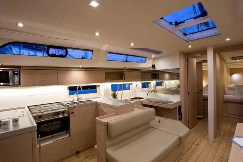 Miss Alice Yacht Photos Pics Luxurious interior of 2018 Beneteau 51.1 yacht with modern kitchen and seating area.