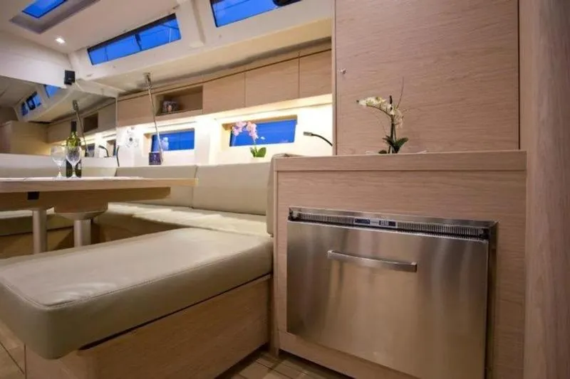 Miss Alice Yacht Photos Pics Luxurious interior of 2018 Beneteau 51.1 yacht with modern seating and elegant decor.
