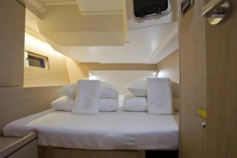 Miss Alice Yacht Photos Pics Luxurious cabin interior of 2018 Beneteau 51.1 yacht with cozy bedding.